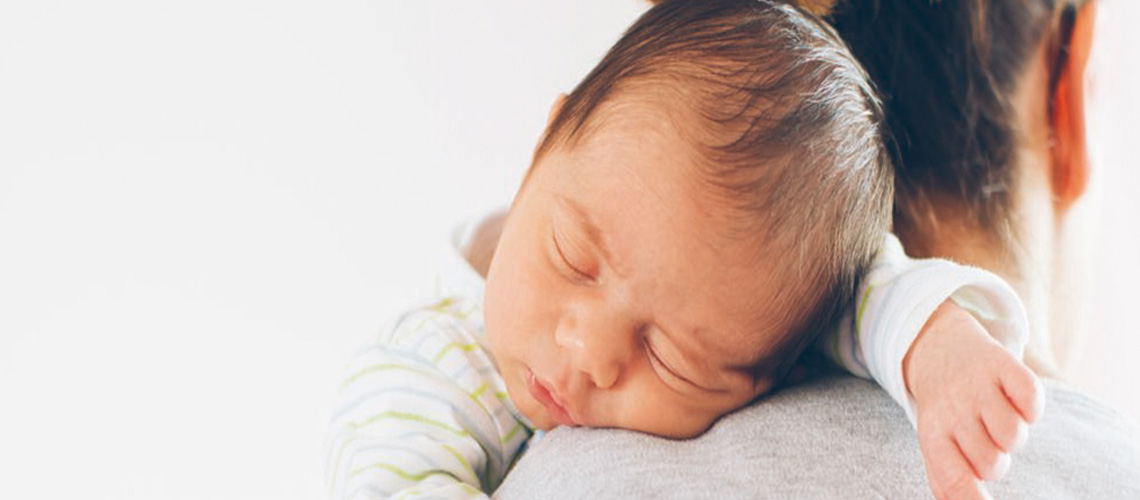 Baby sleeping on a parent's shoulder